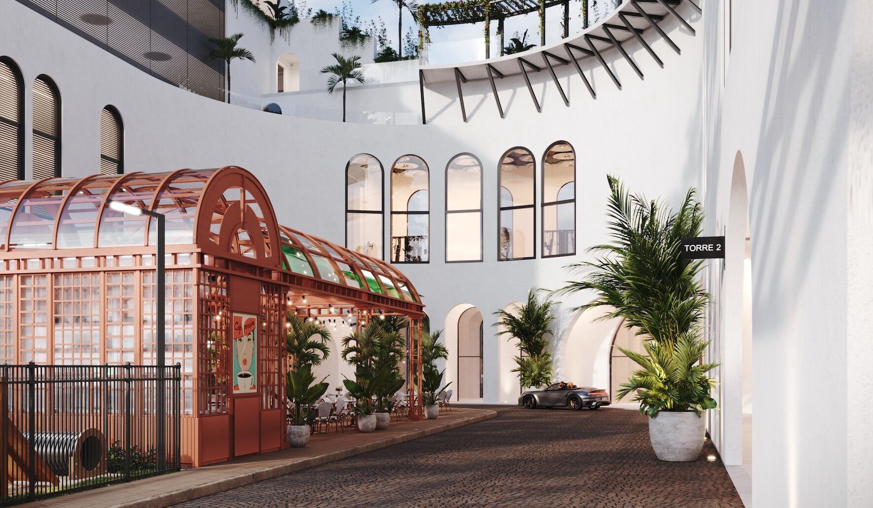 Área social exterior del proyecto Après con jardín, café y fachada curva blanca.