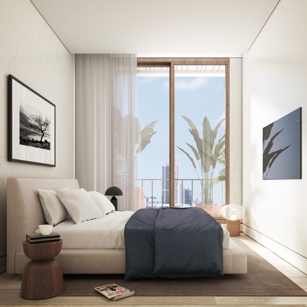 Recámara minimalista con cama beige, vista al balcón y arte en las paredes.